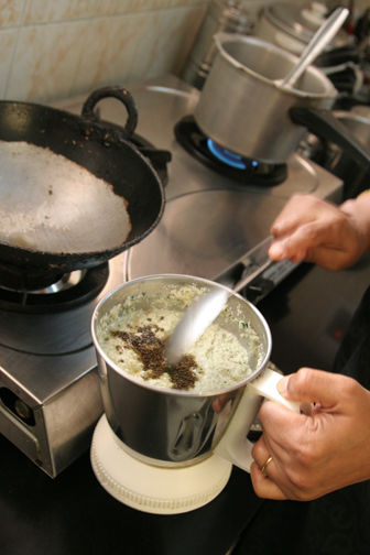 After adding coriander and blending more, stir in the remaining mustard seeds and oil.