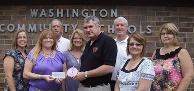 Agents pictured: Left to right, Heather Lujano, Charla Howard (presenting check), Tim Zear, Cheryl Kurtz, Dr Mike Jorgensen (accepting the check), Myron Graber, Connie Larsen and Rhonda Wilson.  Photo Courtesy:  Charla Howard