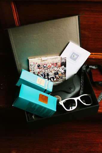 David gave Lisa a thoughtful grouping of gifts: white Ray-Ban Wayfarers for a bridal way to block the flashing bulbs, a Tom Ford fragrance she'd been lusting over, the latest Mumford & Sons album to listen to while she got ready, and a card with a private message. David gave Lisa a thoughtful grouping of gifts: white Ray-Ban Wayfarers for a bridal way to block the flashing bulbs, a Tom Ford fragrance she'd been lusting over, the latest Mumford & Sons album to listen to while she got ready, and a card with a private message.