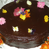 chocolate cake with chocolate ganache and edible flowers