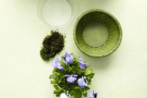 If you make an arrangement in a basket, make sure to line it.  Again, fill the liner with pea gravel for drainage then add in the flowers.  Fill the baskets so the arrangements look full but not crowded, then cover with moss.