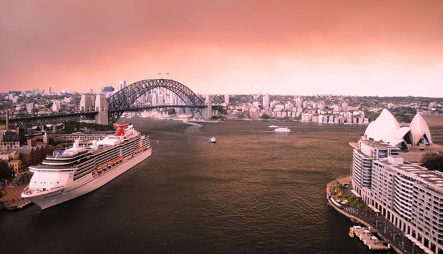 Smoke and ash from bushfires in the Blue Mountains turn the sky red over the Sydney Harbour Bridge, Opera House, and North Sydney, 16 October 2013. Photo: Alana Fisher / Twitter