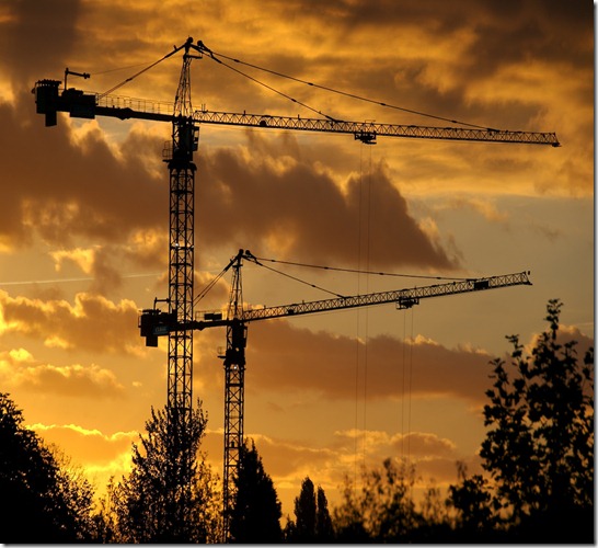 construction_cranes_in_the_sunset