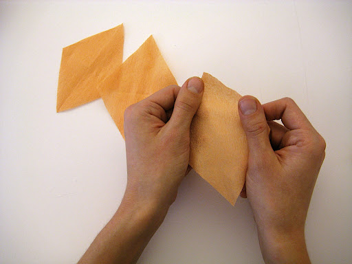 Stretch out the paper for each petal by tugging lightly across the grain.