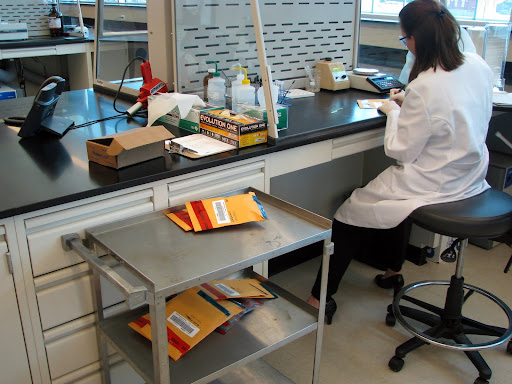 A drug chemistry technician preparing evidence. (Photo credit: Jeremy Shreckhise)