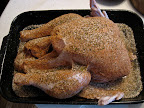 The raw turkey is covered in Cajun spices.