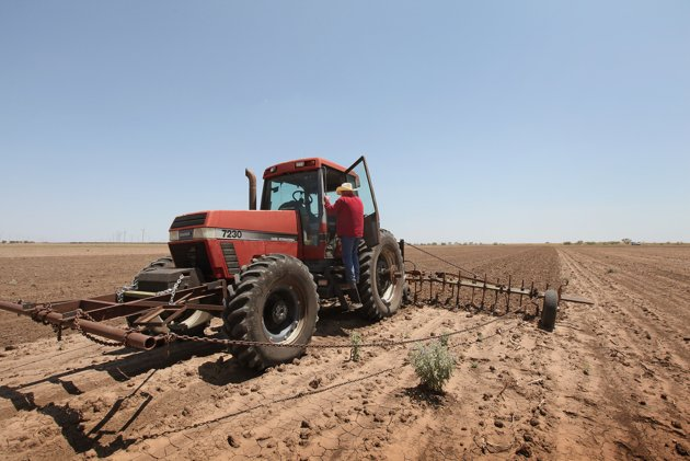 A farmer plows up a field where crops failed because of a severe drought in the region, in Texas in 2011. Scott Olson / AFP Photo