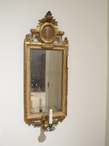 This Gustavian mirrored sconce (one of a pair) is circa 1780-1795.