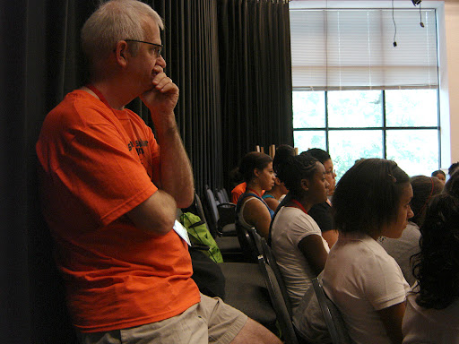 Dr. Bruce Cohen takes a break from exercises with the kids to listen to Professor Westenberg. (photo credit: Sam Senovich)