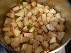 Sugar, vinegar, apples, and raisins are added and brought to a boil.