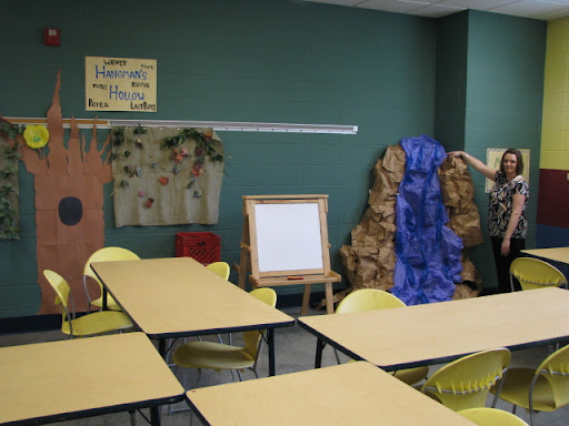 Membership Coordinator Leslie Lambeth points out her favorite piece, a waterfall, from the Art Room.