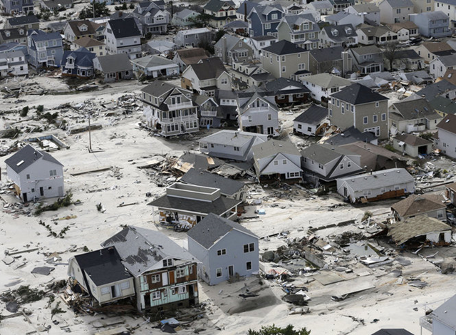 This aerial photo shows the destroyed homes left in the wake of superstorm Sandy on Wednesday, 31 October 2012, in Seaside Heights, New Jersey. New Jersey got the brunt of Sandy, which made landfall in the state and killed six people. A peak of 2.7 million customers were without power. Mike Groll / AP Photo