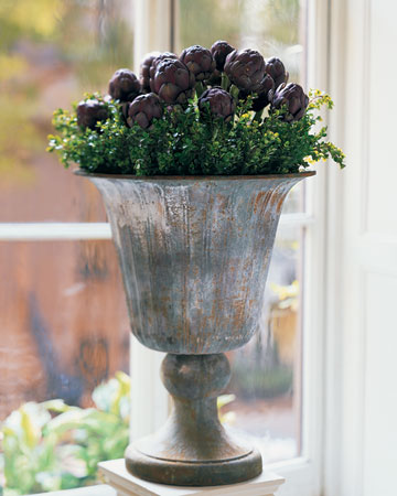 Artichoke Arrangement: This waxen, globed vegetable is more appropriate than you might think for an arrangement, considering the edible head of an artichoke is actually an immature flower. Purple ones with long stems may be specially ordered through a florist.