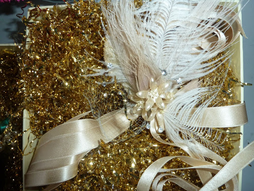 Here's the maid of honor's corsage, which boasts millinery details and soft, satin ribbon. It was made by Brown Paper Designs.