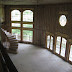 Great room 2 stories high with spiral stairs and monumental windows.   www.grewdesign.com