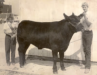 1983 Beef Queen Deb (Bohr) Vittetoe stands with champion beef showman, Dave Richardson.  Vittetoe was a member of the 4-H Maidens from 1975-1883.  She explained, “One valuable skill I learned [in 4-H] and use today is sewing.  Even though most do not sew clothing like they used to years ago, I use my sewing skills often fixing zippers, sewing buttons, hemming pants, etc.  I am so glad my mom took the time and patience to teach us four girls those skills.”   Vittetoe has had three of her own children go through the 4-H program as well and enjoys seeing former 4-H friends from years back at the fair each year.  Photo Courtesy:  Washington County Extension.
