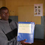 PatrickinKeenYouthMalawiofficewithDCFRNbook.jpg