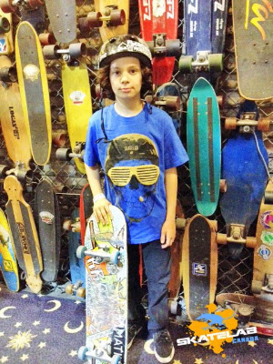 I do not know this little guy or the location where this was taken at but all these boards are old classics and there are 2 of our boards in the pic.