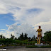Statue of David at Baywalk along Times Beach shoreline, against a cloudy blue sky.