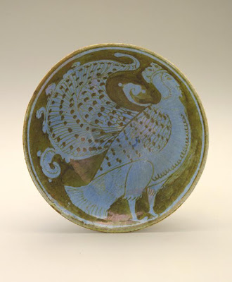 Bowl | Origin:  Probably Kashan,  Iran | Period: late 12th century | Details:  Preoccupation with surface decoration reached new levels of technical sophistication with the use of metal-based "luster" pigmentsÂ—a combination of copper and silverÂ—in twelfth-century Iran. The pigment was applied to the cold body of an already glazed tile or vessel, which was refired in a specially constructed kiln that allowed the metallic oxides to adhere to the vessel. The result was a shimmering lustrous surface rivaling those of gold and silver metal objects. This small bowl, adorned with a human-headed bird, one of the most frequently depicted mythical creatures in medieval Persian art, is characteristic of this exacting technique. | Type: Stone-paste painted over glaze with luster | Size: H: 7.8  W: 17.3   D: 17.3  cm | Museum Code: S1997.113 | Photograph and description taken from Freer and the Sackler (Smithsonian) Museums.