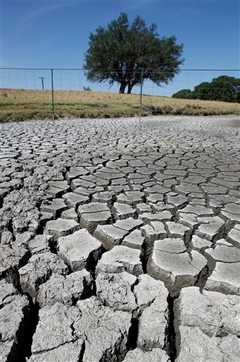 Large cracks form as Brady Creek continues to bake in the sun, Tuesday, 26 July 2011, near Eden, Texas. The area has received less than three inches of rain this year and 60 100-degree days. Eric Gay / AP Photo