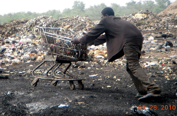 A boy pushing a shopping cart load of wires going for burning in the Agbogbloshie ghetto in Accra, Ghana, 28 March 2010. Kwei Quartey