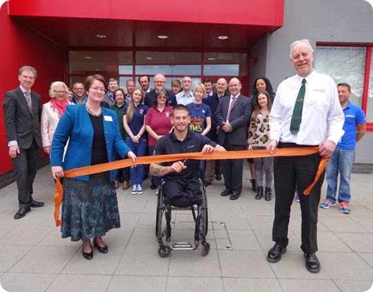 Joe Townsend cuts the ribbon outside the centre in front of dignitaries and guests