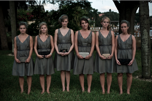 The bridesmaids, in their gray dresses and birdcage veils. Here, they hold the clutches they carried down the aisle (in lieu of bouquets). The bridesmaids, in their gray dresses and birdcage veils. Here, they hold the clutches they carried down the aisle (in lieu of bouquets).