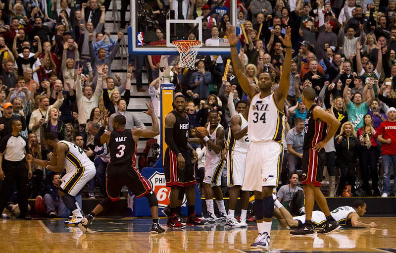 Utah Jazz guard Devin Harris (5) is fouled by Miami's Dwayne Wade (3) and makes the shot, setting up the three-point that won the game.