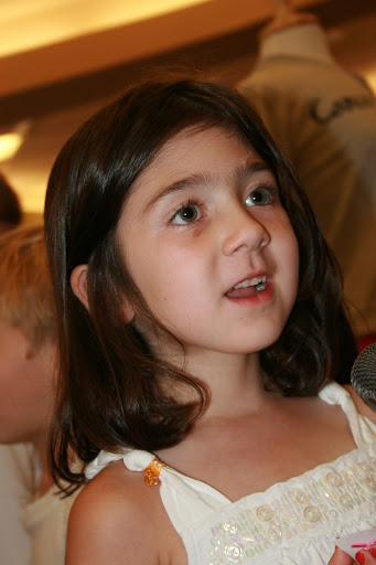 A young girl by the name of Genesis talks about her multi-colored knitted cap. (photo credit: James Mulvenon)