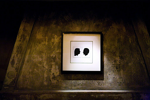 A framed print of the silhouettes hung on the fireplace inside. A framed print of the silhouettes hung on the fireplace inside.