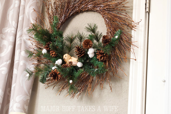 Bird on Evergreens for winter wreath. World Market inspired wreath. A fun twist on a Christmas wreath. Make a winter wreath that will last all season long and well past. This cute grapevine wreath is adorned with a tiny bird, pinecones, greenery and pom poms. You won't believe how cheap and easy this was to make! And so simple! #Christmas #winter #holiday #wreath #nature #knockoff Bird on Evergreens for winter wreath. World Market inspired wreath. A fun twist on a Christmas wreath. Make a winter wreath that will last all season long and well past. This cute grapevine wreath is adorned with a tiny bird, pinecones, greenery and pom poms. You won't believe how cheap and easy this was to make! And so simple! #Christmas #winter #holiday #wreath #nature #knockoff