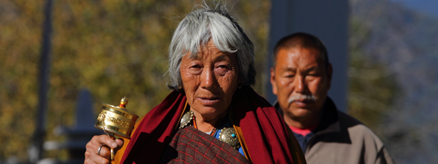 Elderly Woman offering prayers at Memorial Chorten, Thimphu, Bhutan
