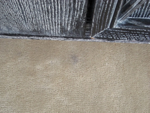 This stain is a result of a vase leaking on the top of my armoire.