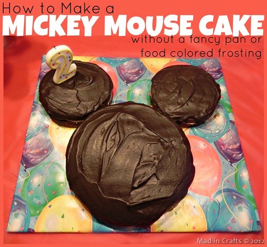 Homemade Mickey Mouse Cake on a cake board sitting on a red tablecloth