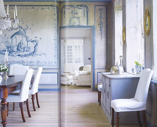 Softened grandeur: bare wood floor, simple white slipcovers and polished mahogany.