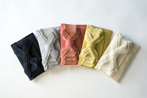 The clutch's dramatic bow makes it an ideal accessory for simpler dress.