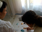 Here Marisa and Corinne are crafting some sequins on to a place card.