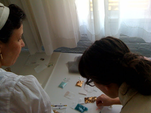 Here Marisa and Corinne are crafting some sequins on to a place card.