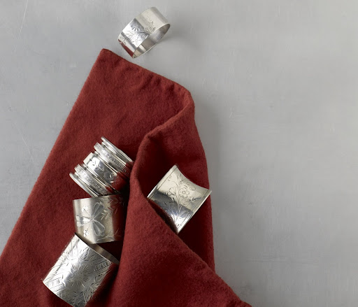 Bright-cut napkin rings bring a touch of brilliance to the dinner hour. By the 1870's, napkin rings had evolved from simple, unadorned bands to ovals, barrels, and octagons lavishly engraved with botanical patterns and other fanciful, minutely crafted designs. Bright-cut napkin rings bring a touch of brilliance to the dinner hour. By the 1870's, napkin rings had evolved from simple, unadorned bands to ovals, barrels, and octagons lavishly engraved with botanical patterns and other fanciful, minutely crafted designs.