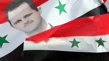 111209044859-flag-showing-portrait-of-syrian-president-carried-by-pro-regime-supporters-during-rally-in-damascus-dec-9-story-top