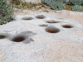 Fresh rainwater filled morteros in Piedras Grandes