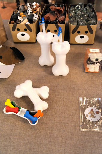 Here are the bone crayons, bone sippy cups from Celebrate Express, miniature dog puppets, noses, bouncy balls, and a dog baseball hat from Oriental Trading, a dog towel favor from toweltreat.com, and cellophane bags from nashvillewraps.com.