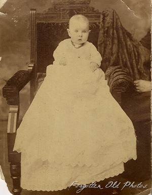 Baby in long gown  DL Antiques