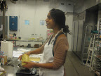 Sam Seneviratne getting into the spirit while she measures chocolate for her pecan bars.