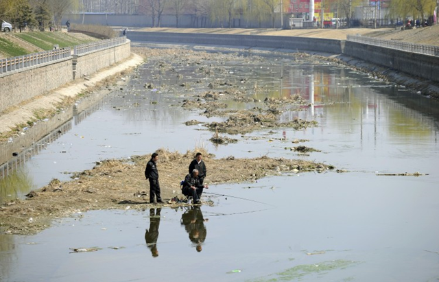 Local residents fish in a polluted river in Beijing on 29 March 2011. The overall environmental situation in China is very grim with all seven major river systems polluted, according to Li Ganjie, Vice Minister of the Chinese Ministry of Environmental Protection, speaking at a press conference on June 3 to discuss the Report of the State of the Environment of China (2010). Liu Jin / AFP / Getty Images