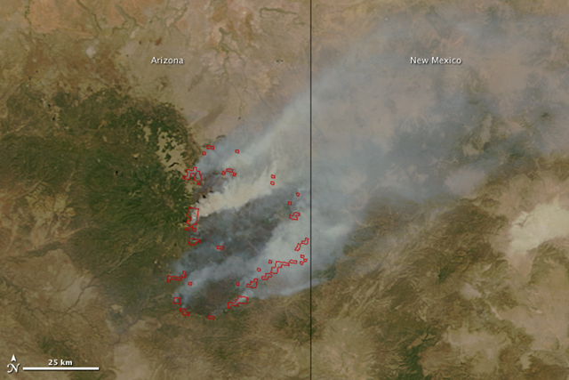 The Moderate Resolution Imaging Spectroradiometer (MODIS) on the Terra satellite acquired this image of the Wallow Fire on June 9, 2011 at 10:55 a.m. local time. Active fire areas are outlined in red. Smoke rises from the most intensely burning areas, but overall, the fire is producing less smoke than in previous days. NASA image courtesy Jeff Schmaltz, MODIS Rapid Response Team at NASA GSFC