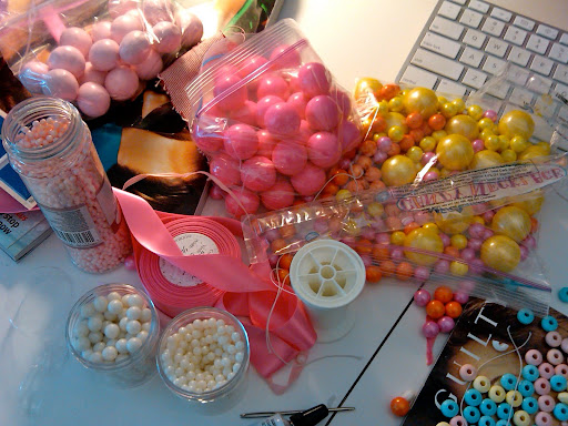 What you're seeing: Fancy Flours pink candy pearls, delicious Madelaine pale-pink malt balls, hot-pink Sweetworks gumballs and pearlized Sixlets candy-coated chocolate-flavored candies, and Midori ribbon in 
