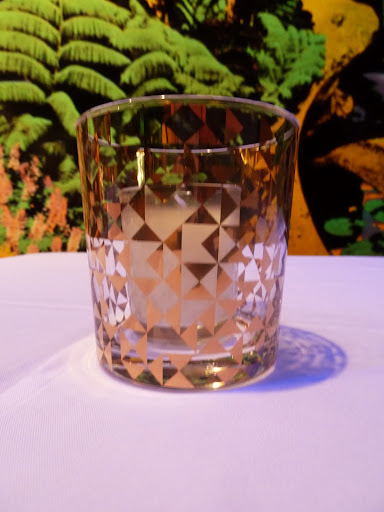 Glasses from Dwell Studio held votive candles. They reflected a warm glow and added a fun geometric pattern to the cocktail tables. Glasses from Dwell Studio held votive candles. They reflected a warm glow and added a fun geometric pattern to the cocktail tables.