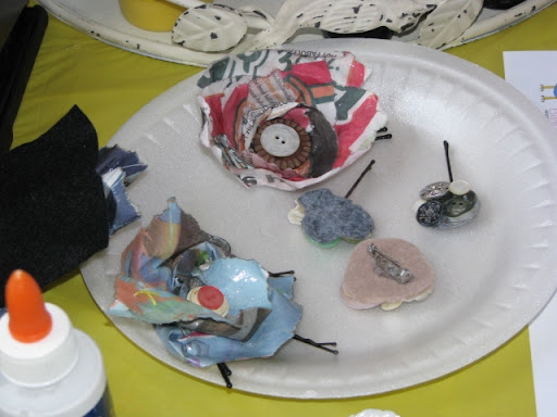 Hair Clips made from old newspapers and buttons.